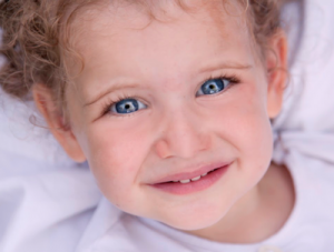 close up of blue eyed toddler